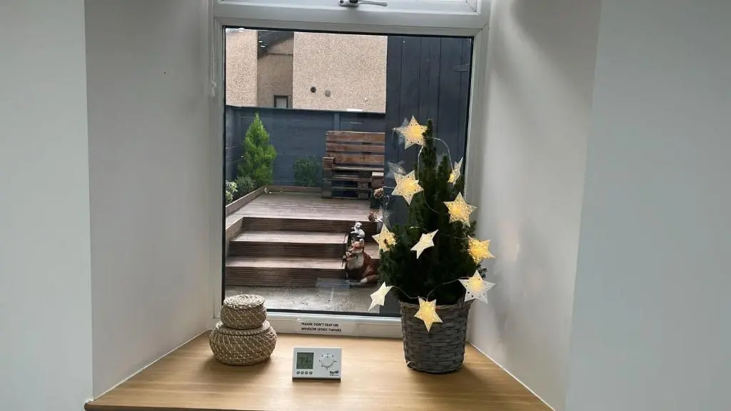 a room with a vase of flowers on a table at 51 Innes Street Apartment in Inverness