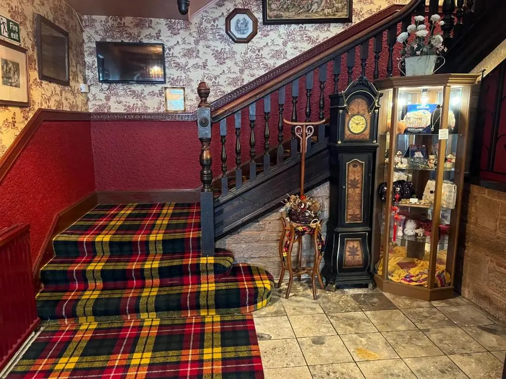 a room with a staircase with a plaid carpet at Strathpeffer Hotel in Strathpeffer