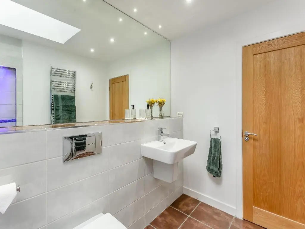 a bathroom with a sink and a mirror at The Bothy in Lochend