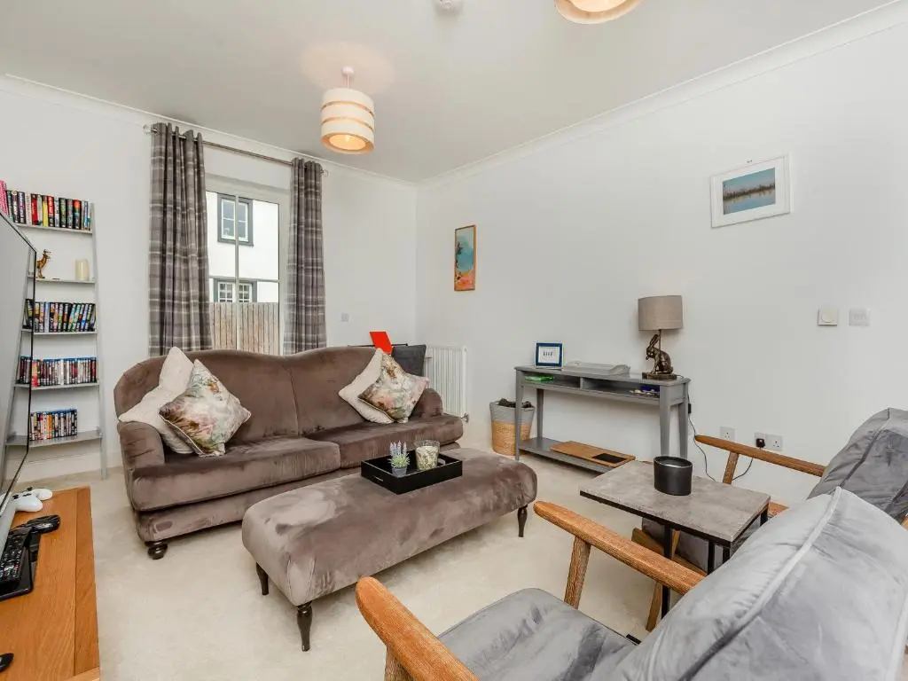 a living room with two couches and a table at One The Loan in Croy