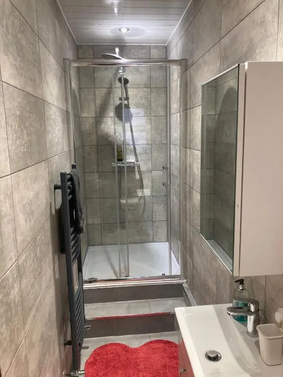 a bathroom with a shower and a sink at 2 Bed Central Ness Apart - May Court in Inverness