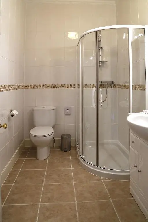 a bathroom with a shower and a toilet and a sink at Carnach House in Nairn