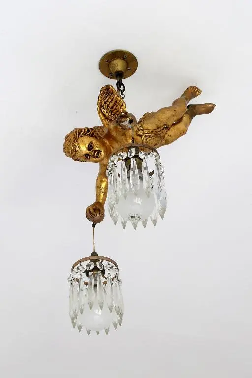 a golden bird chandelier hanging from a ceiling at Carnach House in Nairn