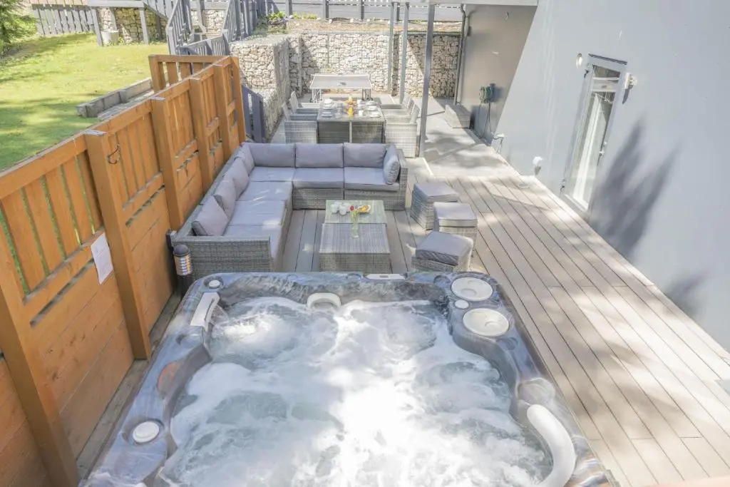a hot tub on the deck of a house at The Neuk in Kincraig