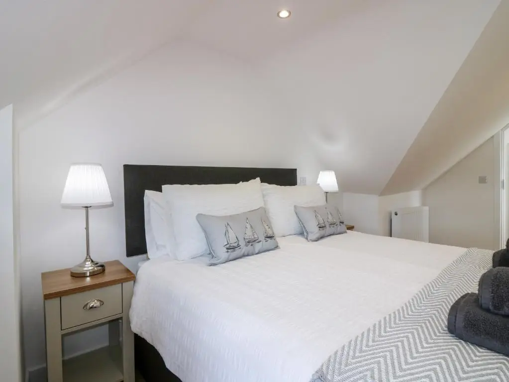 a bedroom with a large bed with white sheets and pillows at 111A Main Street in Banff