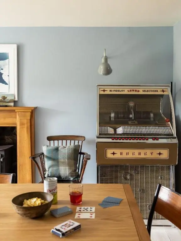 a kitchen with a stove and a wooden table at Exclusive use - The Coach House in Banchory