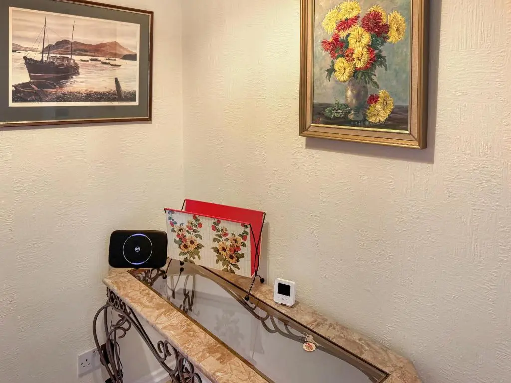 a room with a counter with a vase of flowers at Damil Cottage - Uk44789 in Bridge of Alford