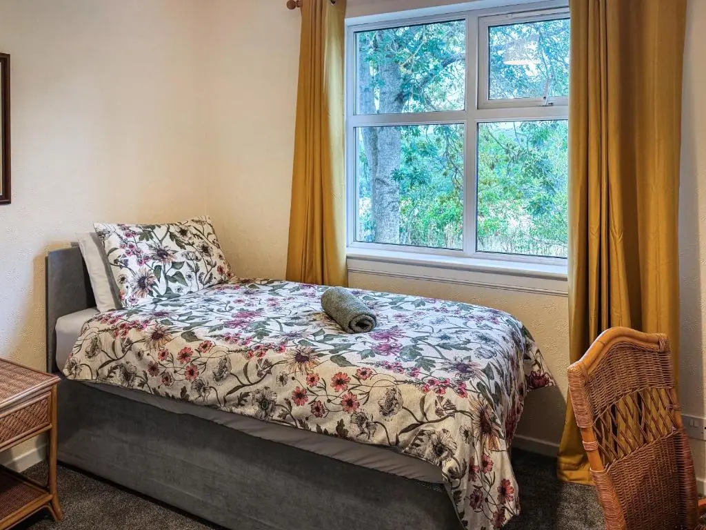 a bedroom with a bed and a window at Damil Cottage - Uk44789 in Bridge of Alford