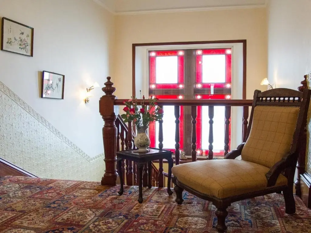 a room with a staircase with a chair and a window at Tali Ayer in Nairn
