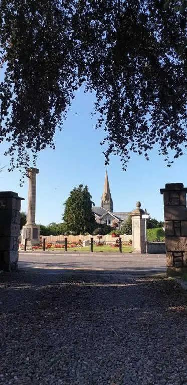 a view of a park with a building and a tree at Tali Ayer in Nairn