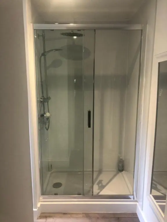 a shower with a glass door in a bathroom at The South Cabin at Easter Arr in Nairn