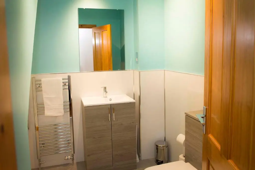 a bathroom with a sink and a mirror at Seafront holiday home in Findochty in Findochty