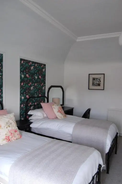 two beds in a room with white walls at Room Only Corbies Rest in Inverness