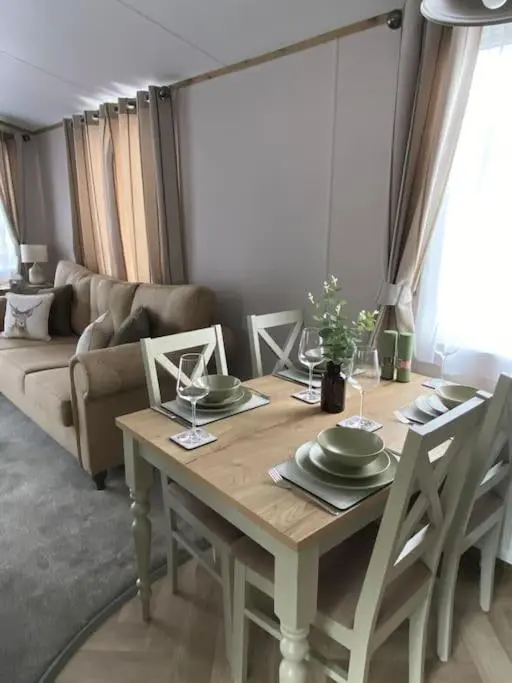 a dining room table with plates and wine glasses at Perfect for country lovers in Grantown on Spey