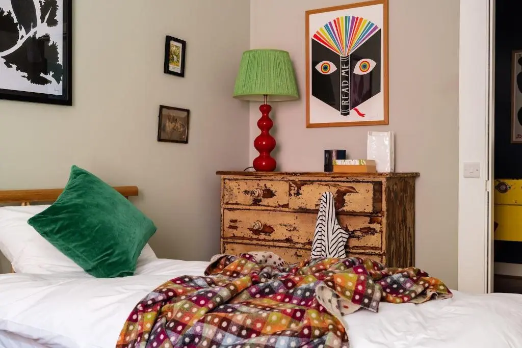 a bedroom with a bed and a table with a lamp at The Corner House in Banchory