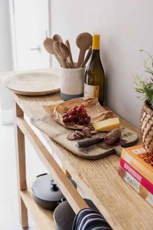a table with a bottle of wine and a plate of food at The Corner House in Banchory