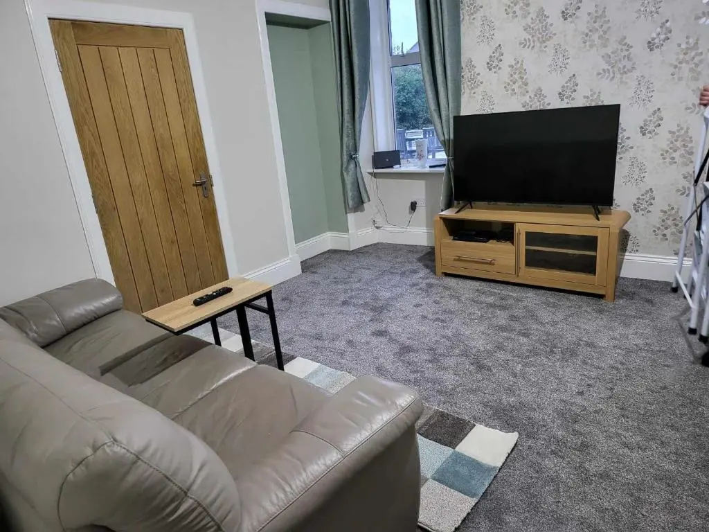 a living room with a couch and a flat screen tv at 16 Northcote Street, Wick in Wick