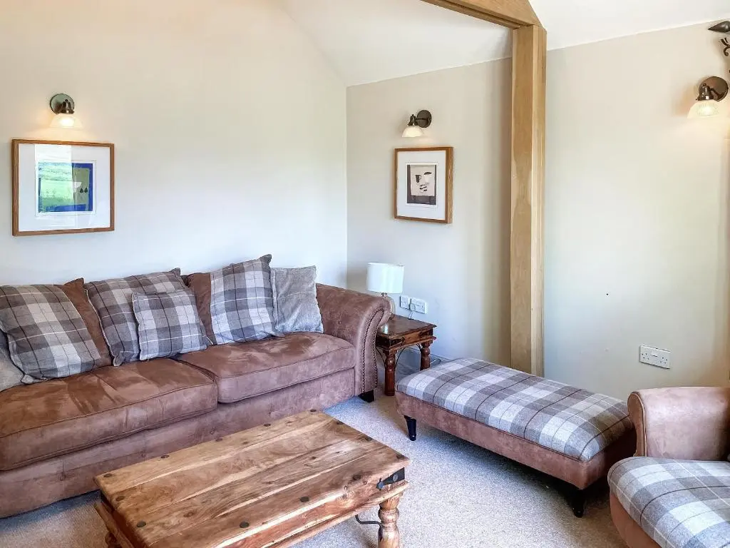 a living room with a couch and a coffee table at Brandy Cottage - Ukc6855 in Millton of Clova