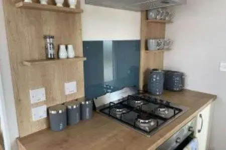 a kitchen with a stove and a counter top at Silver sands holiday park in Lossiemouth