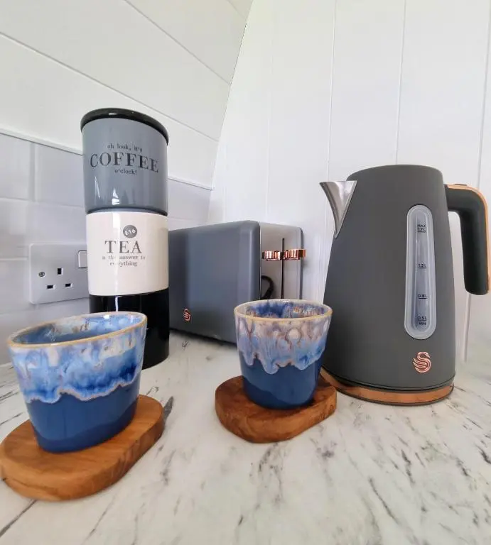 a coffee maker and two cups on a counter at Bombie Glamping Pod in Grantown on Spey