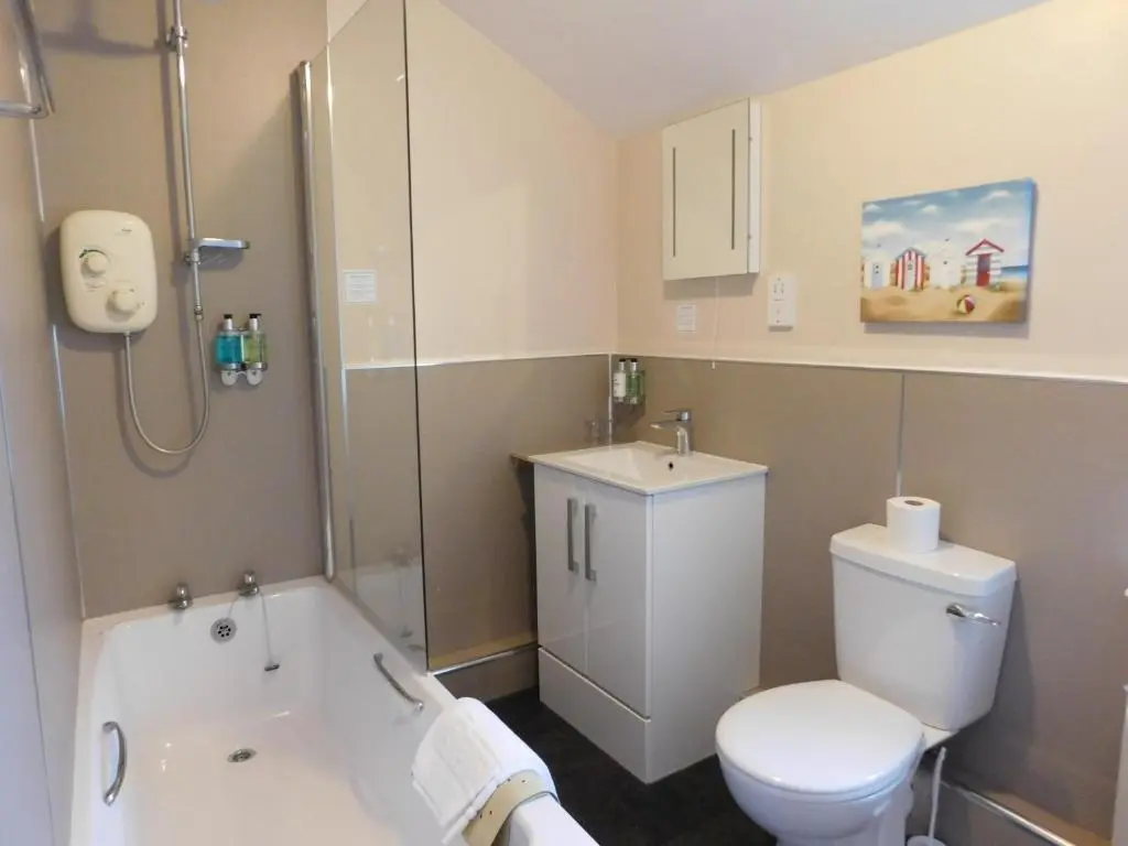 a bathroom with a white tub and a toilet at Cullen Bay Hotel in Cullen