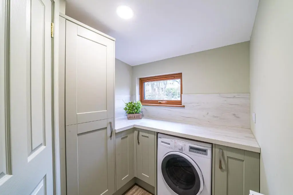a laundry room with a washer and dryer at Gardener\u2019s Cottage with Hot Tub in Blairgowrie