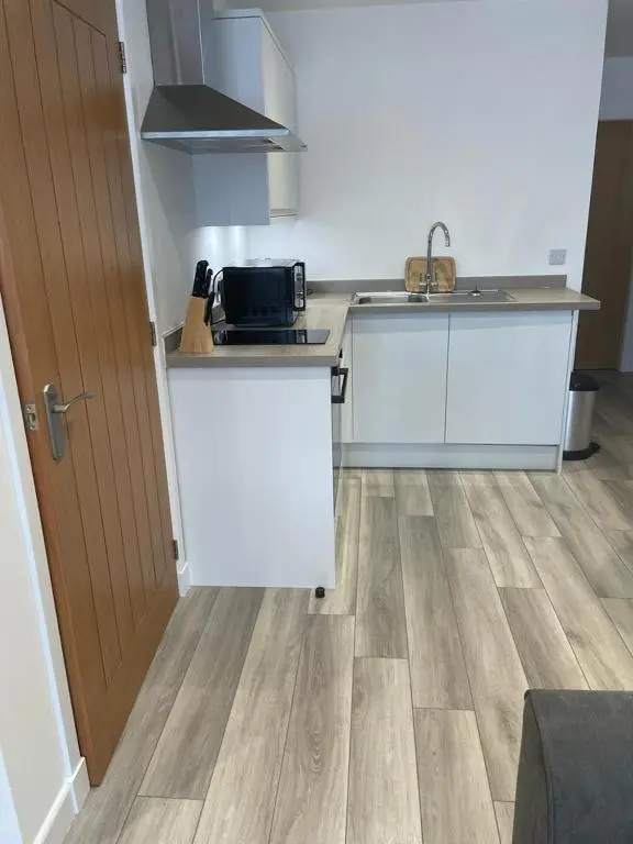 a small kitchen with a sink and a counter top at Simpsons in Lairg