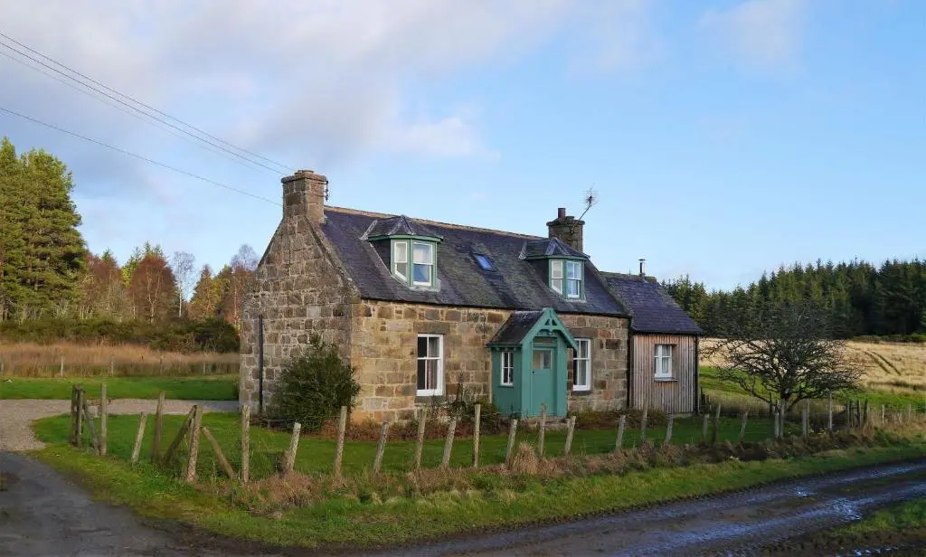 an old stone house on the side of a road at Bogroy in Aberlour