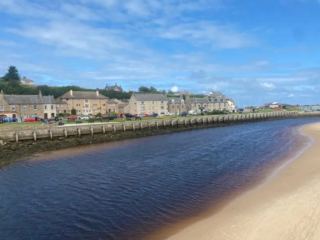 a bridge over a beach with buildings in the background at Seaview in Lossiemouth