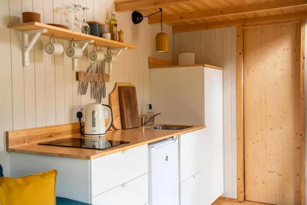 a kitchen with a sink and a counter top at Ailsa- Enchanting Tiny House with wood burner and hot tub in Cairngorms in Ballater