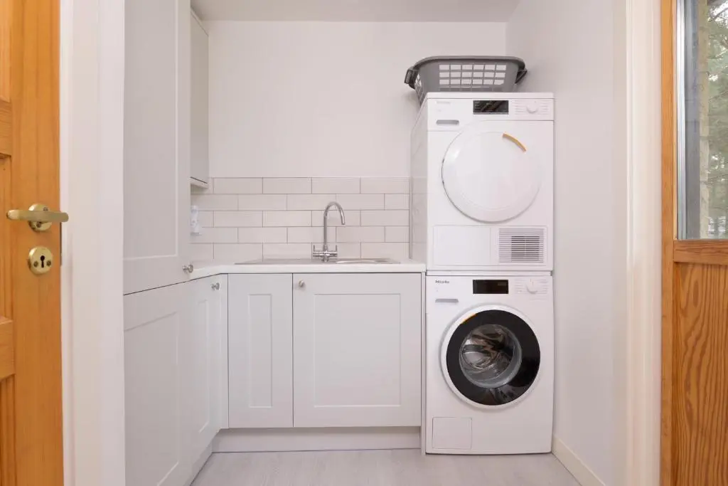 a laundry room with a washing machine and a sink at Ballater Bungalow - 4 bed - Beautiful Garden in Ballater