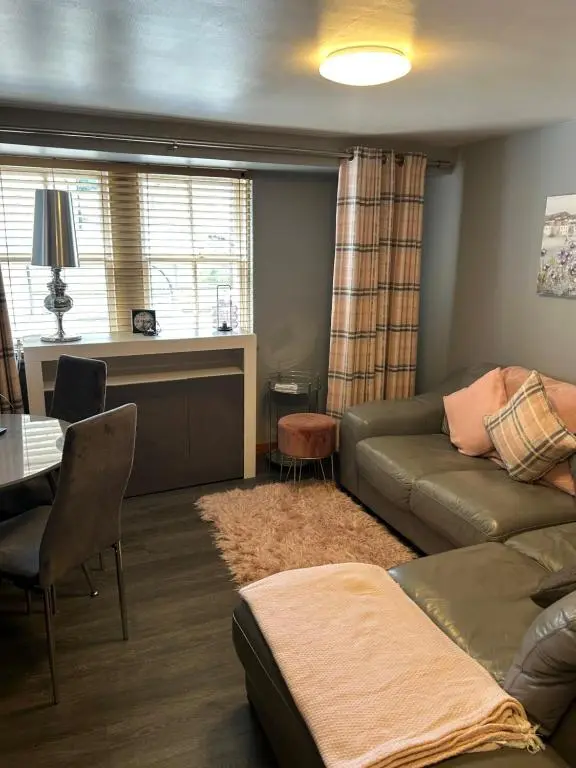 a living room with a couch and a table at Saint Blue Apartment in Tain