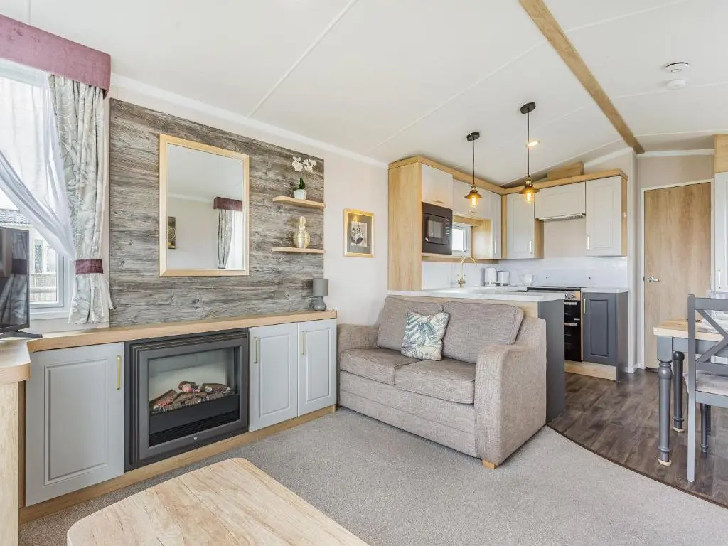 a living room with a couch and a fireplace at The Bordeux in Dornoch