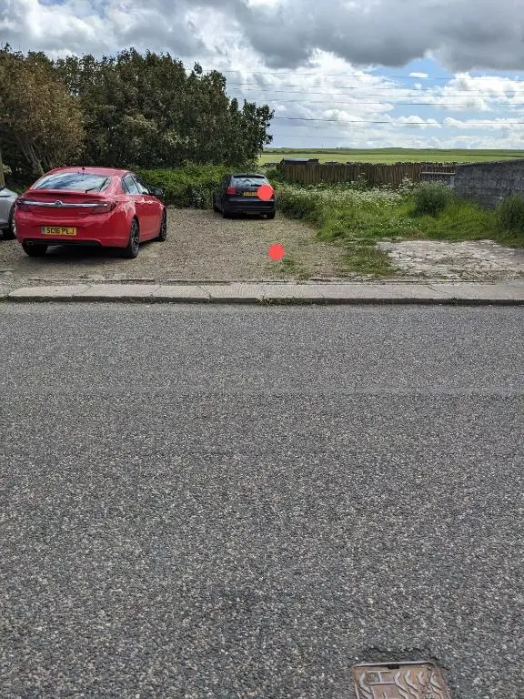 two cars parked on the side of a road at Craigmile Cottage in Fraserburgh