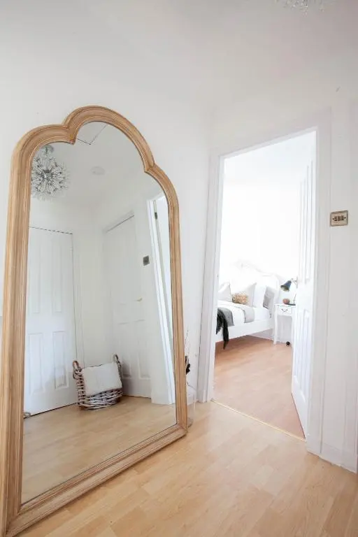 a large mirror in a room with a living room at The River Nest in Dalneigh