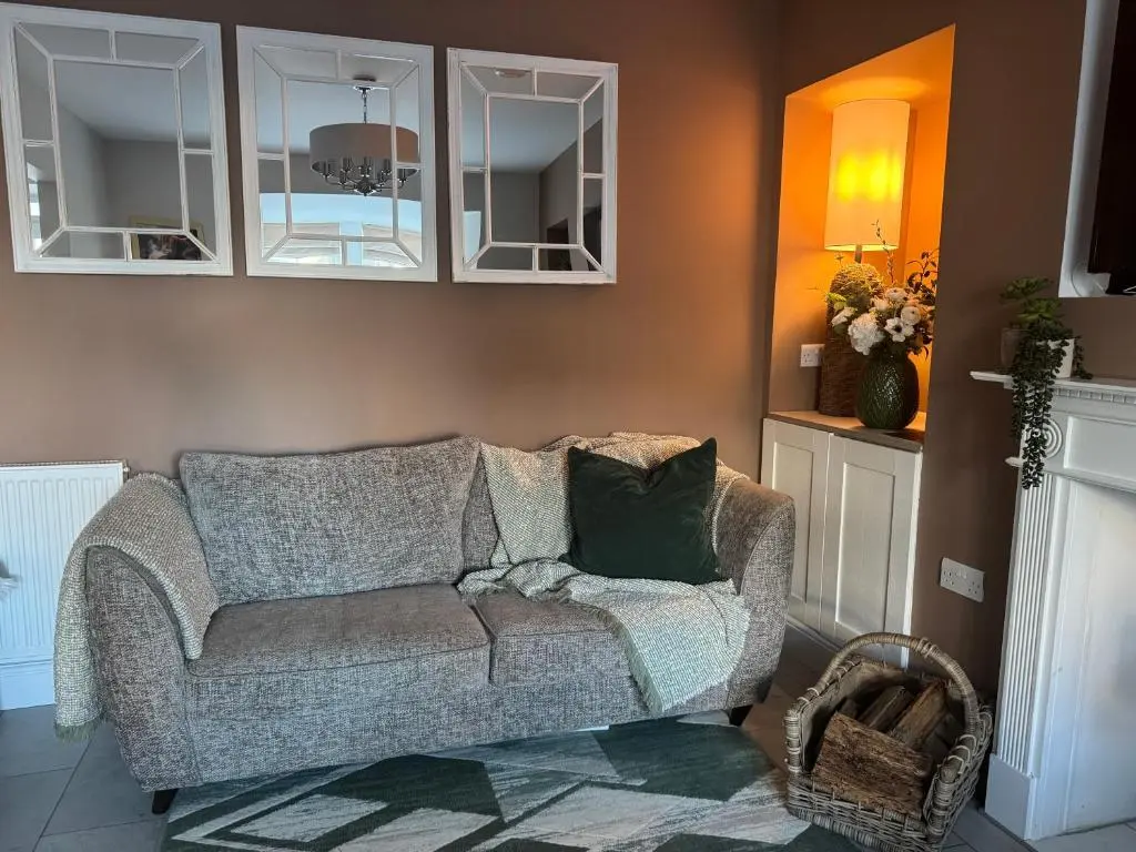 a living room with a couch and some cabinets at Altonhill Cottage - room only in Nairn