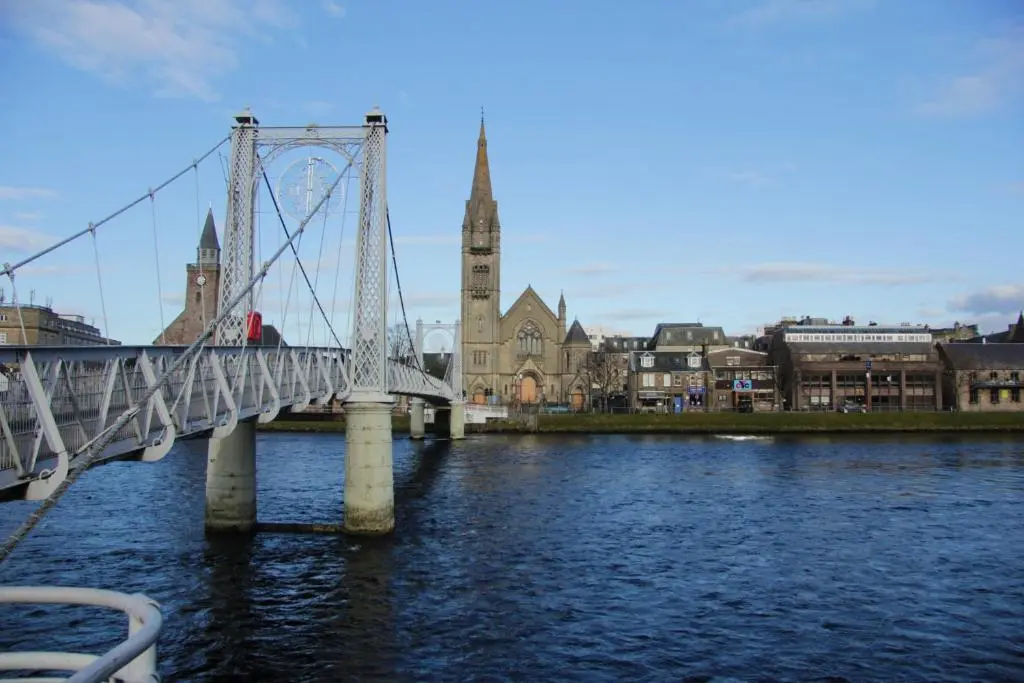 a bridge over a river in a city at Scardroy Homes Inverness - Central 2 Bedroom with Parking WiFi Smart TVs Sleeps up to 6 in Inverness