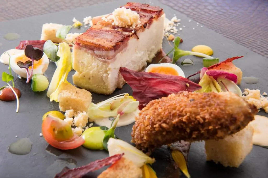 a plate of food with a piece of cake at The Glenmoriston Townhouse Hotel in Inverness