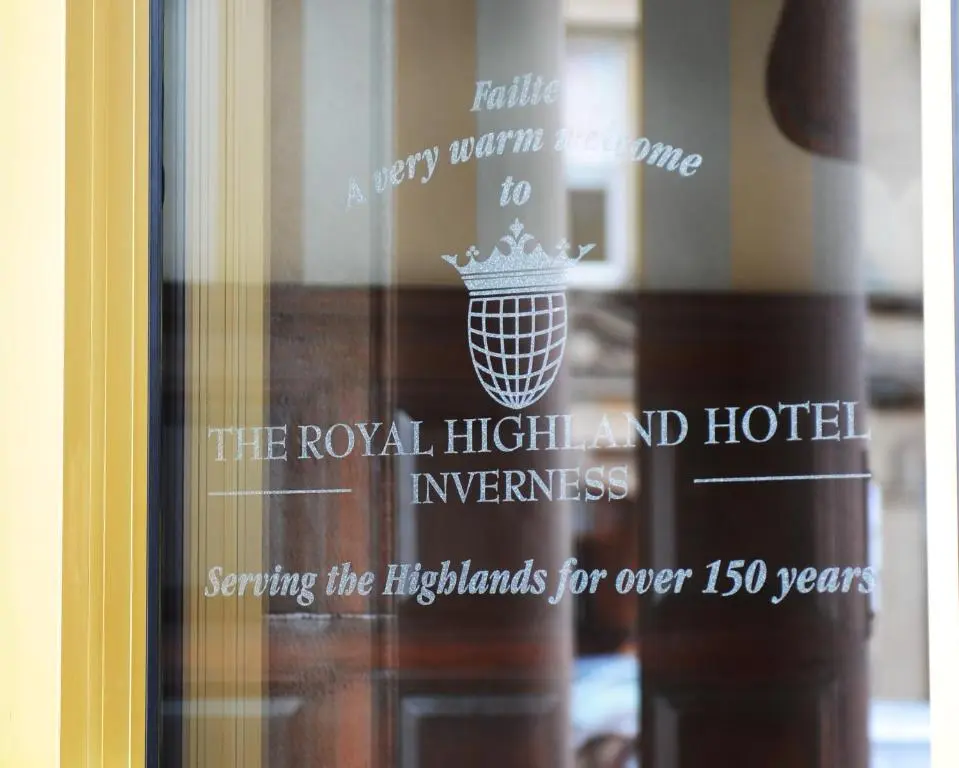 a sign on a glass door of a hotel at The Royal Highland Hotel in Inverness