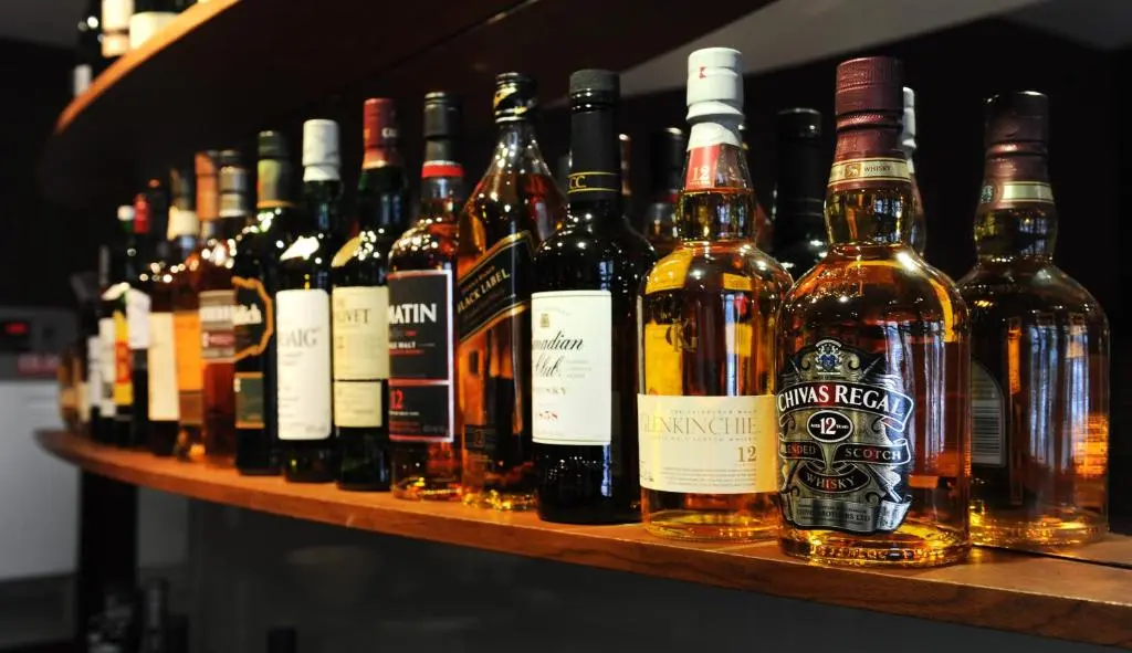 a shelf filled with lots of bottles of wine at The Royal Highland Hotel in Inverness