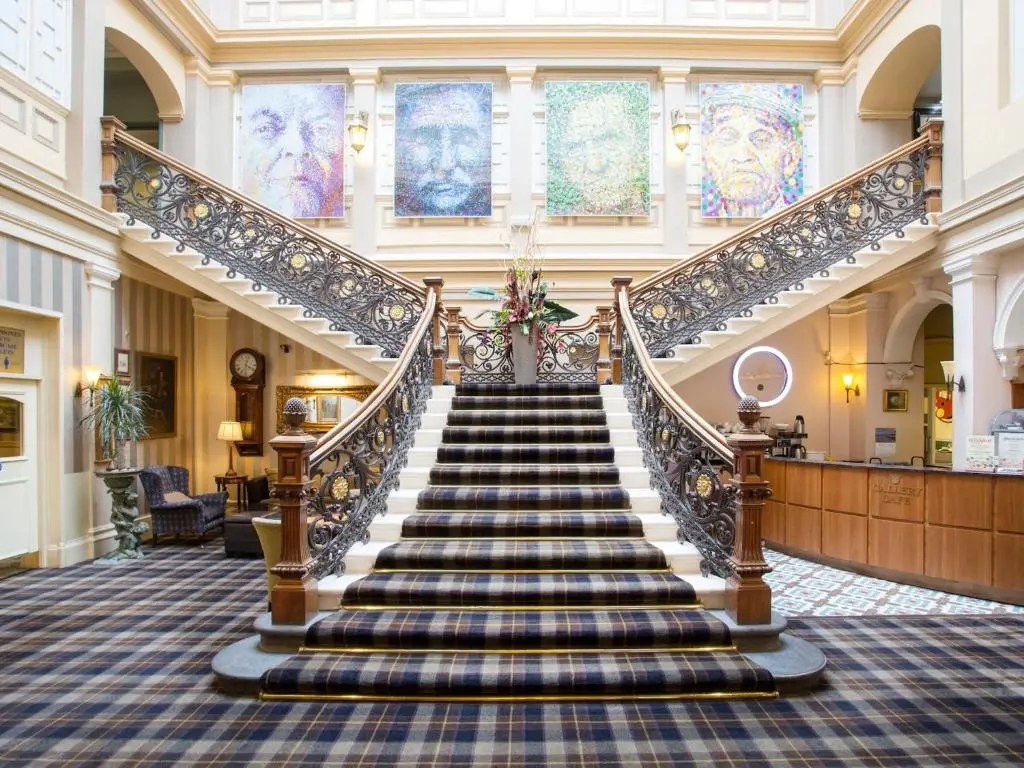 a spiral staircase in a building with a lobby at The Royal Highland Hotel in Inverness