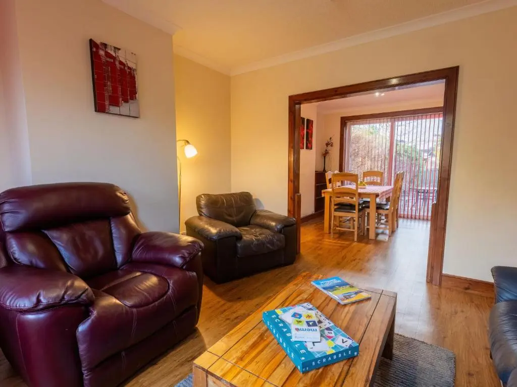 a living room with leather furniture and a table at Holiday Home Beech by Interhome in Inverness