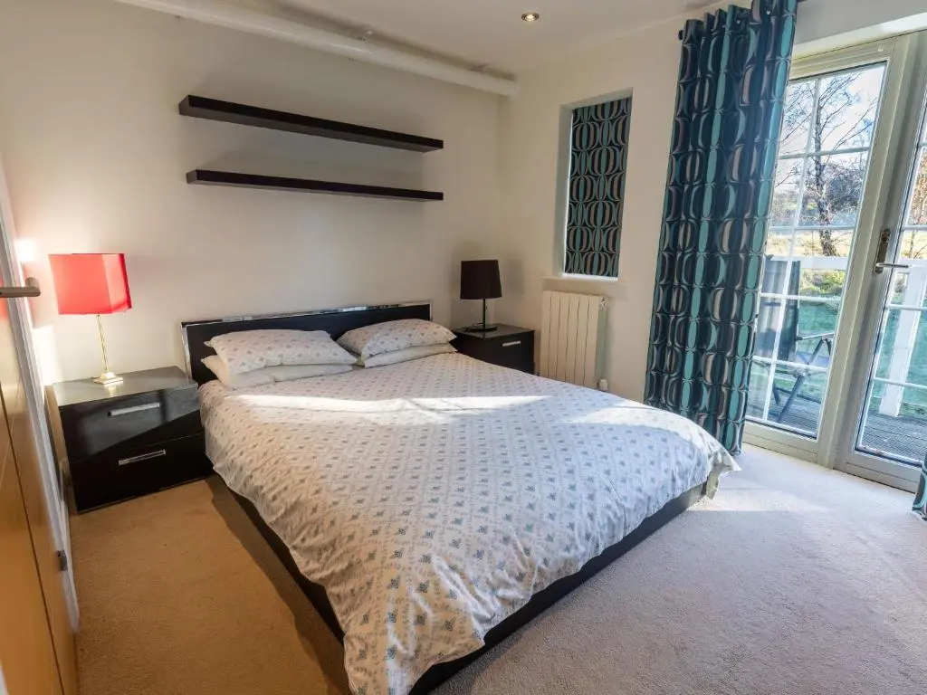 a bedroom with a bed and a large window at Apartment Druid Temple by Interhome in Inverness