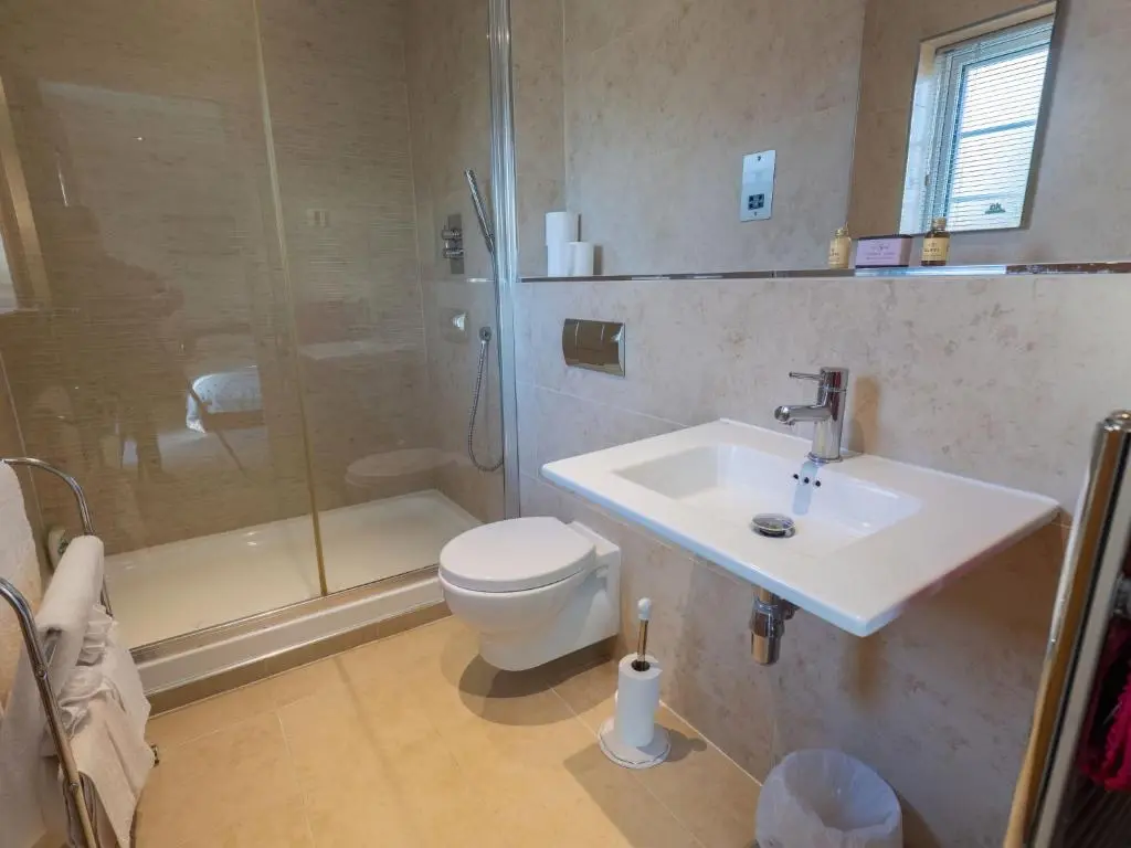 a bathroom with a toilet and a sink and a shower at Apartment Druid Temple by Interhome in Inverness