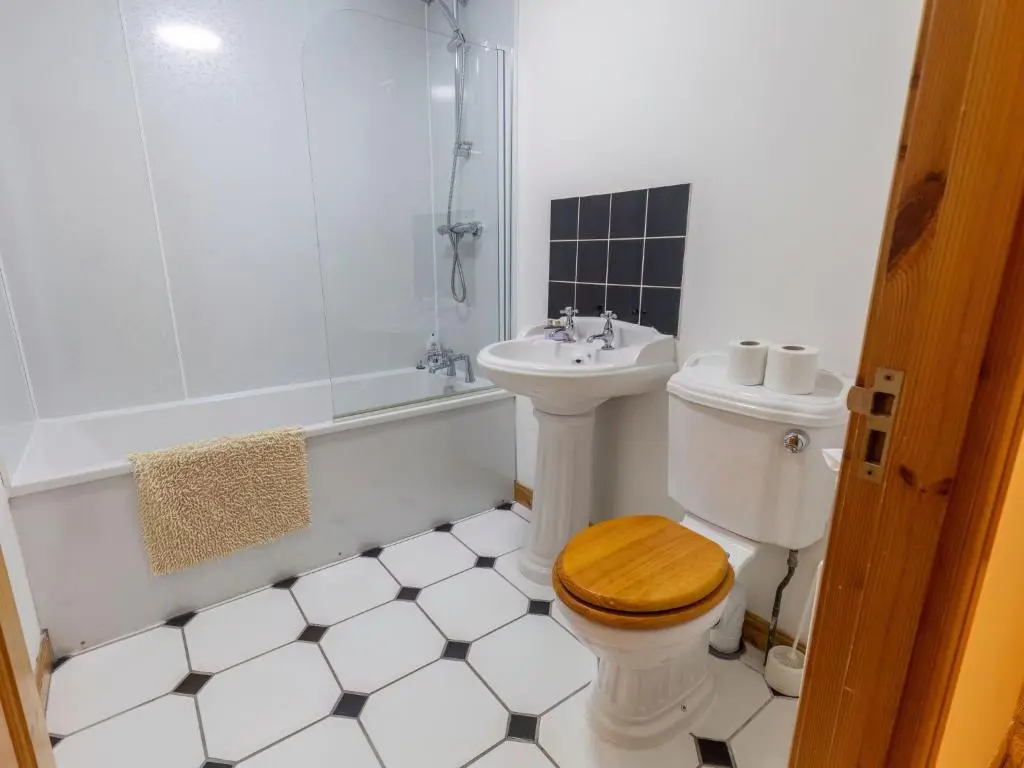 a bathroom with a toilet and a sink and a shower at Holiday Home Ardness Place by Interhome in Inverness