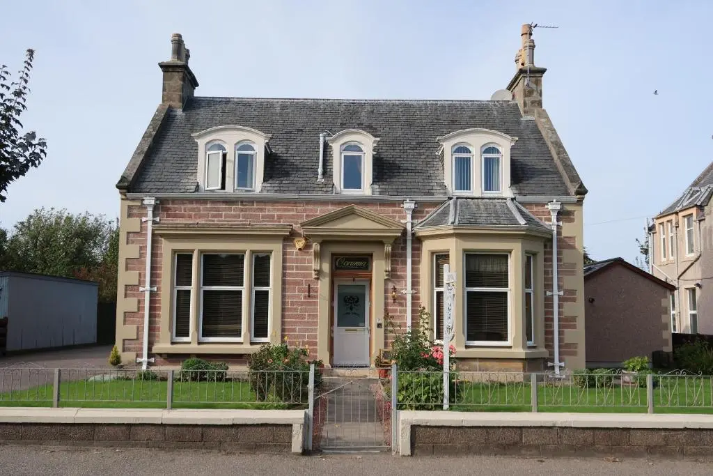 a brick house with a gray roof at Corunna Bed & Breakfast and Corunna Cottage in Inverness