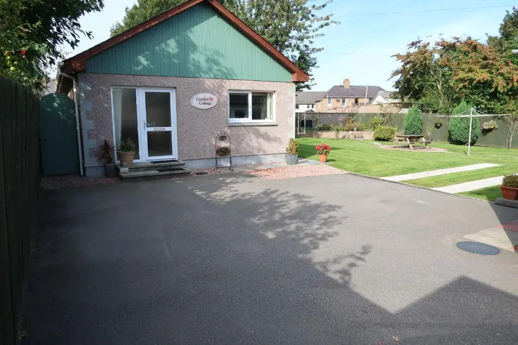 a house with a driveway in front of it at Corunna Bed & Breakfast and Corunna Cottage in Inverness