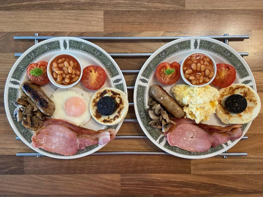two plates of breakfast food on a table at Corunna Bed & Breakfast and Corunna Cottage in Inverness