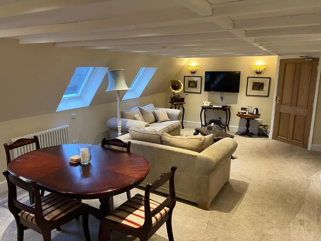 a living room with a couch and a table at Dalmunzie Castle Hotel in Glenshee