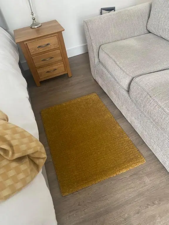 a living room with a couch and a table at Aberlour Apartment 92 B in Aberlour